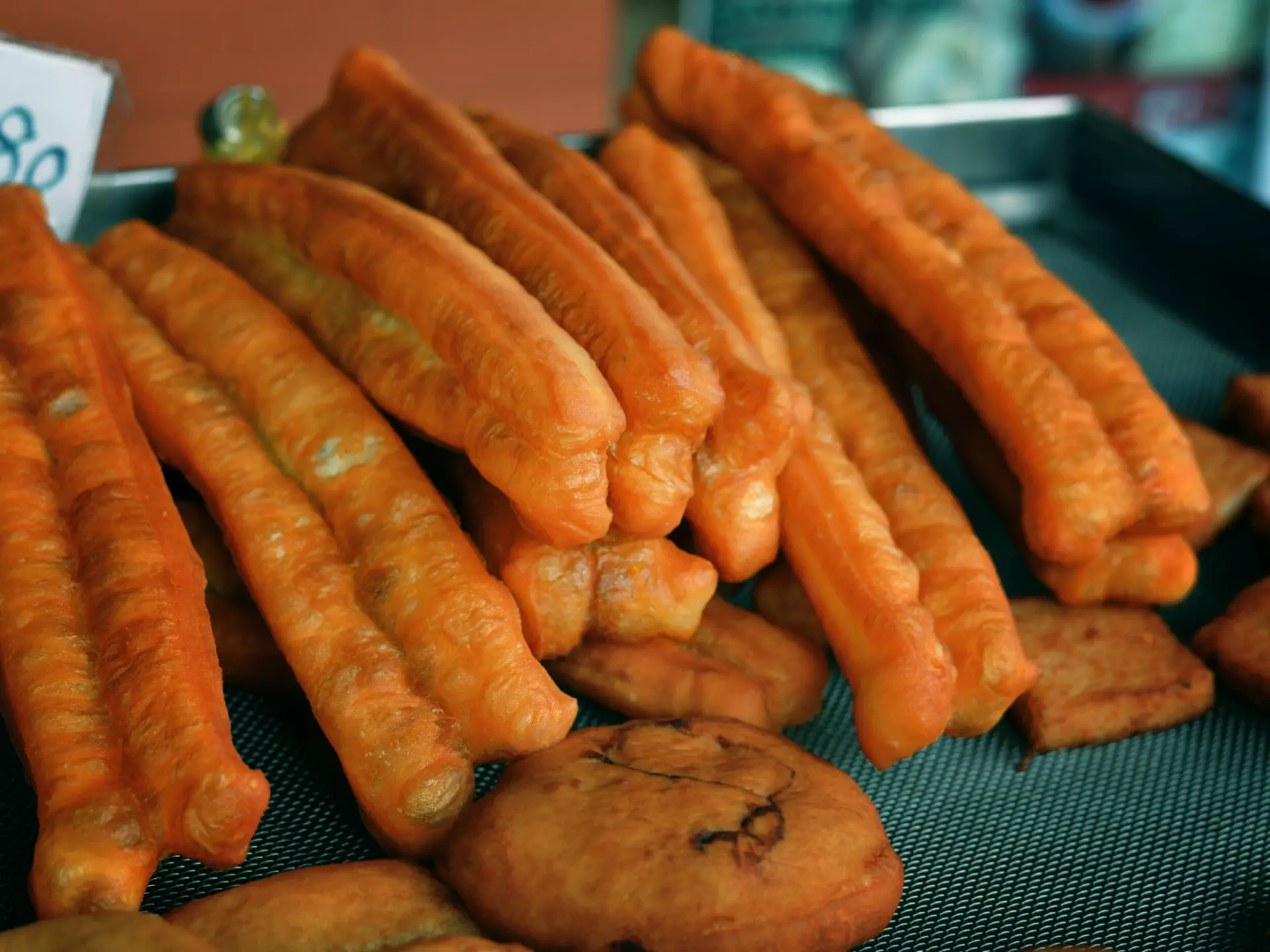 Two large cans of Saltbox Brewery's Crustacean Elation Ale sitting side-by-side on a bar table.