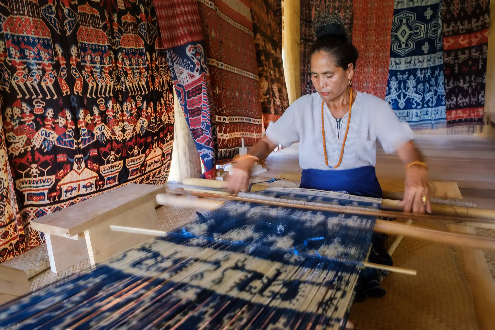 Mauliru, Haumara, East Sumba, East Nusa Tenggara, Indonesia: A Sumbanese woman holding up the tradition of ikat weaving