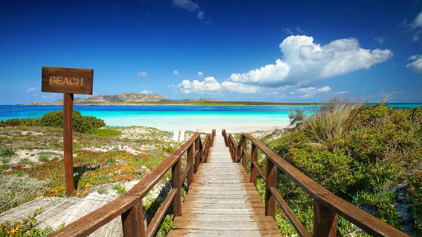 A pathway leading towards Spiaggia della Pelosa, one of Sardinia's most beautiful beaches. Jenny Sturm/Shutterstock