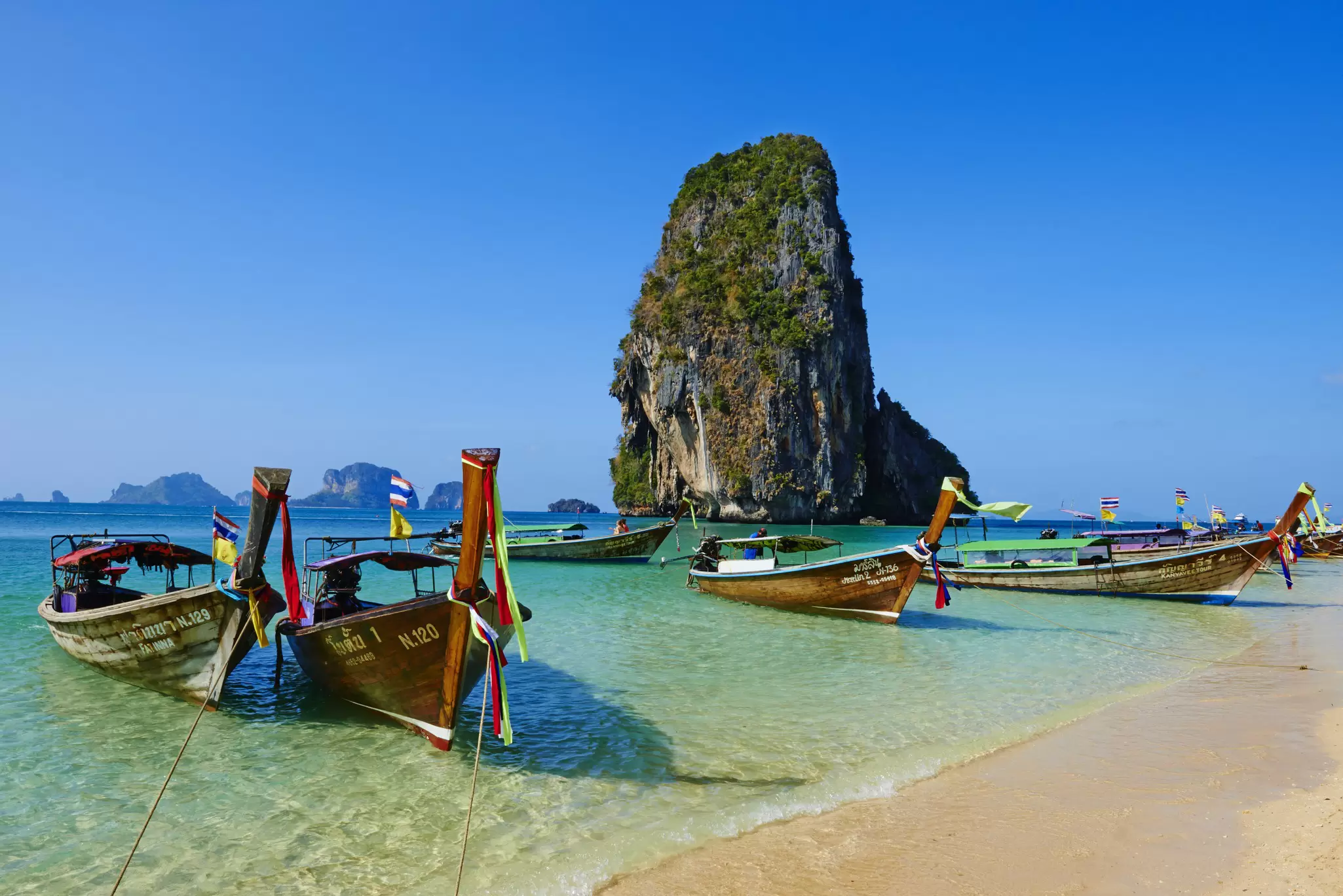 View of boats docked at Hat Railay beach in Krabi Province, Thailand.