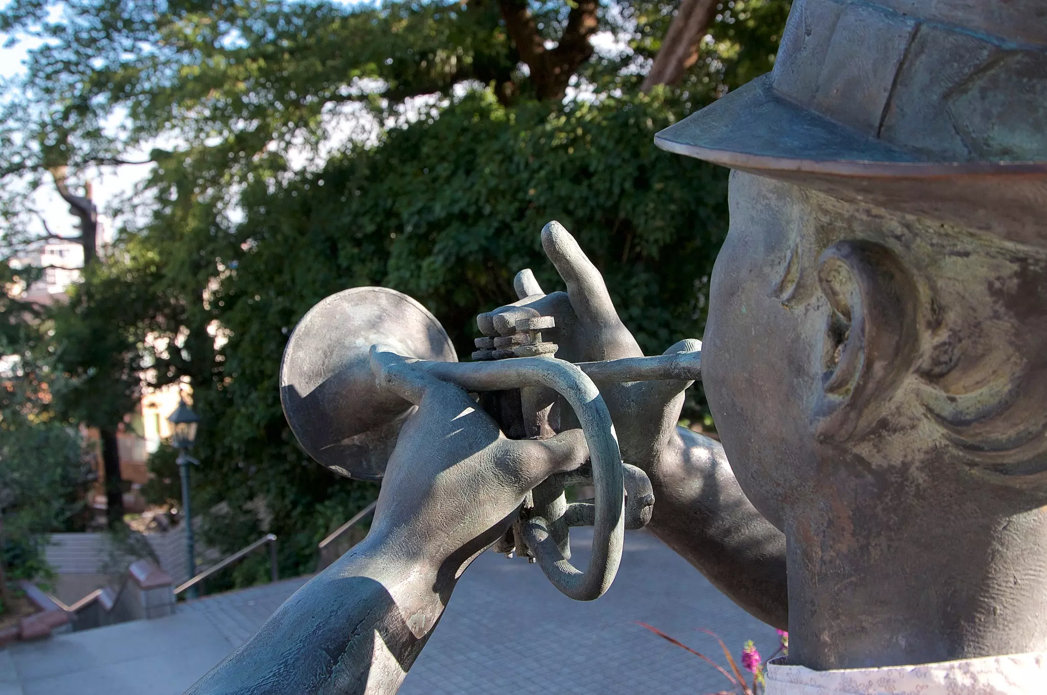 A statue of a trumpet player seen from behind. 