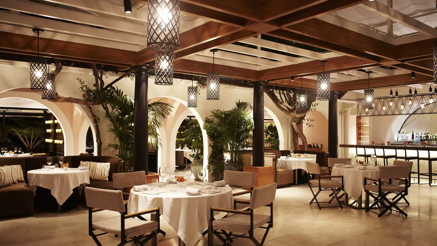 The interior of the Wolfgang Puck restaurant at the Hotel Bel-Air with a view out to the garden terrace