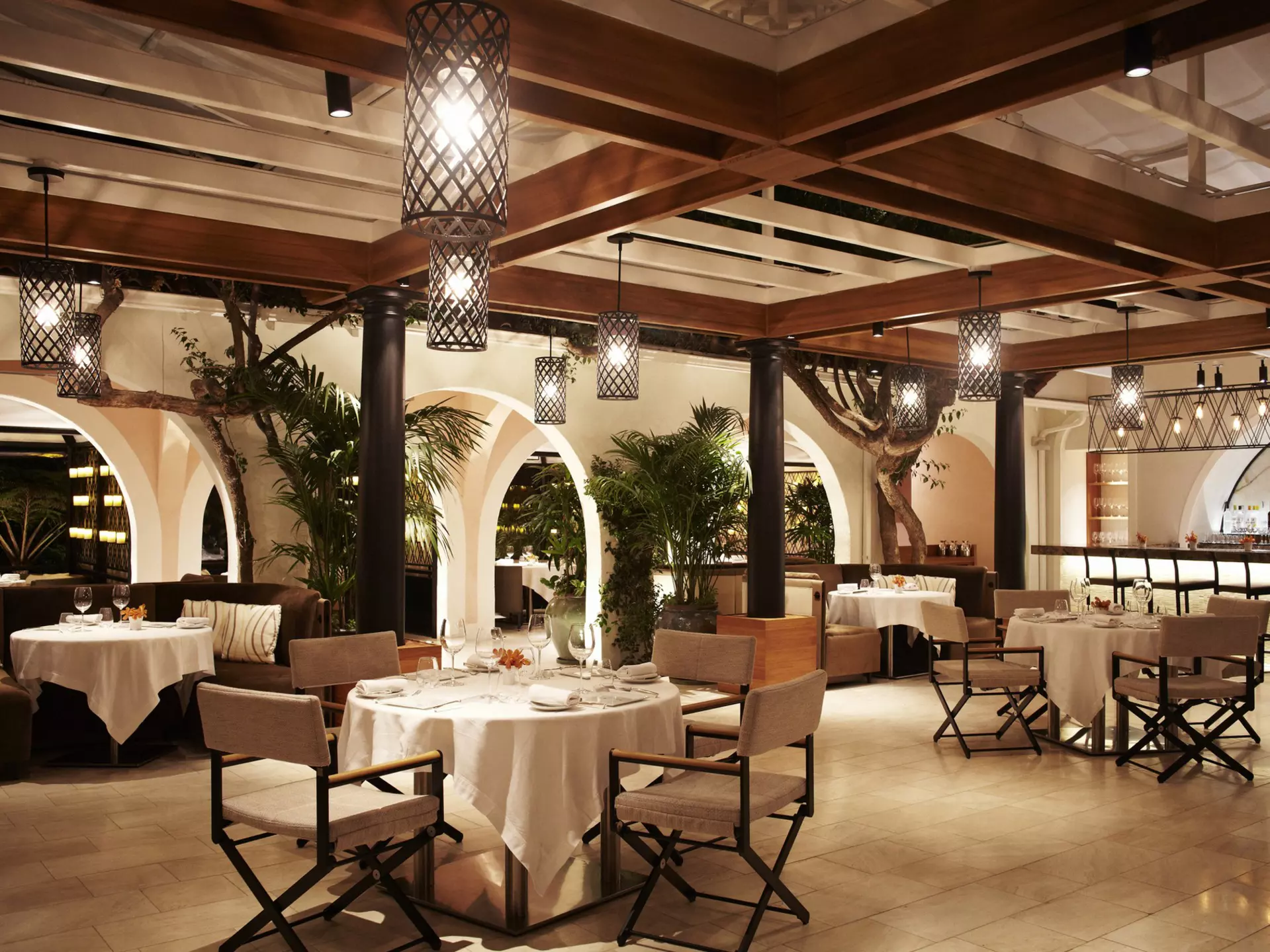 The interior of the Wolfgang Puck restaurant at the Hotel Bel-Air with a view out to the garden terrace