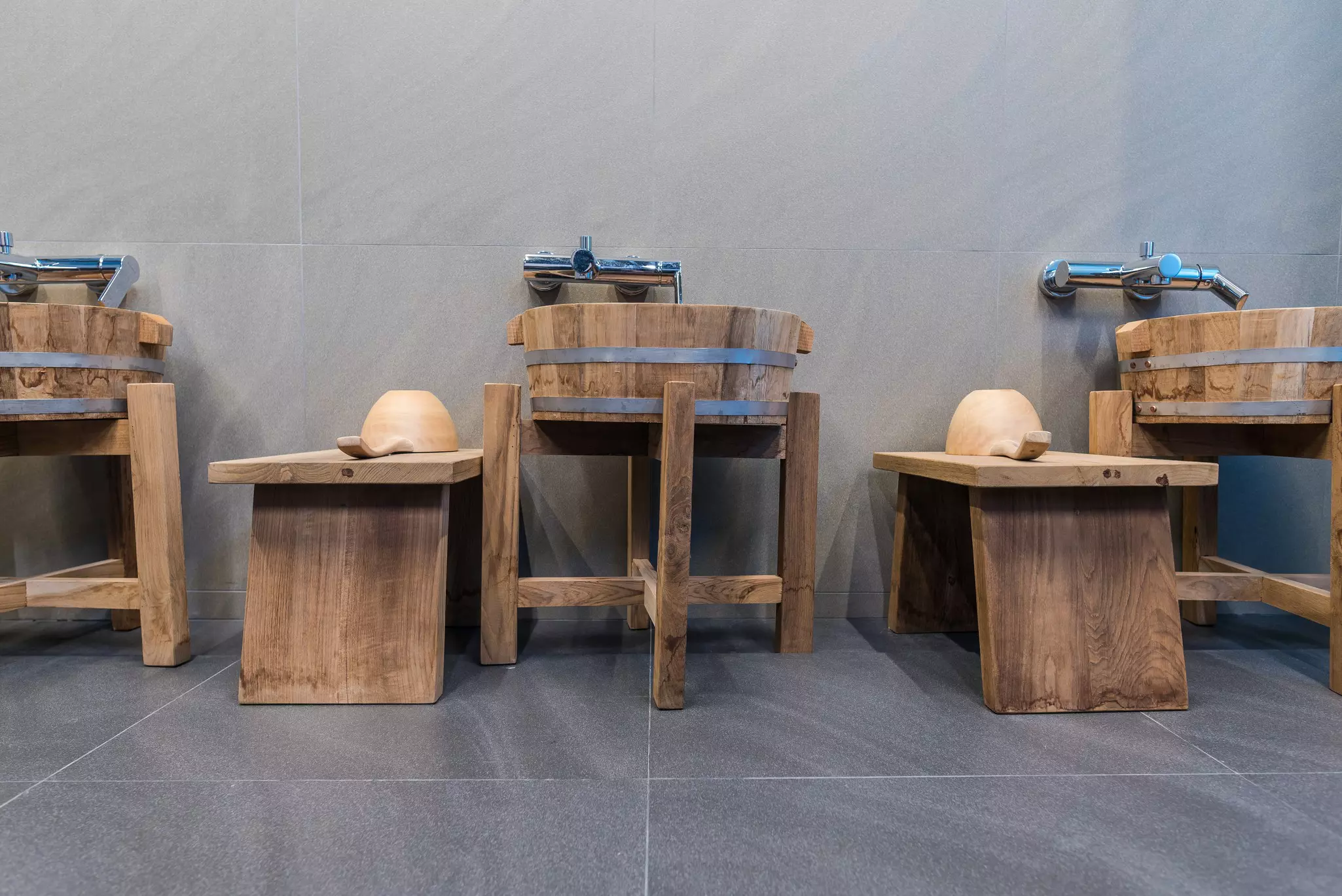 Wooden stools and washbasins.