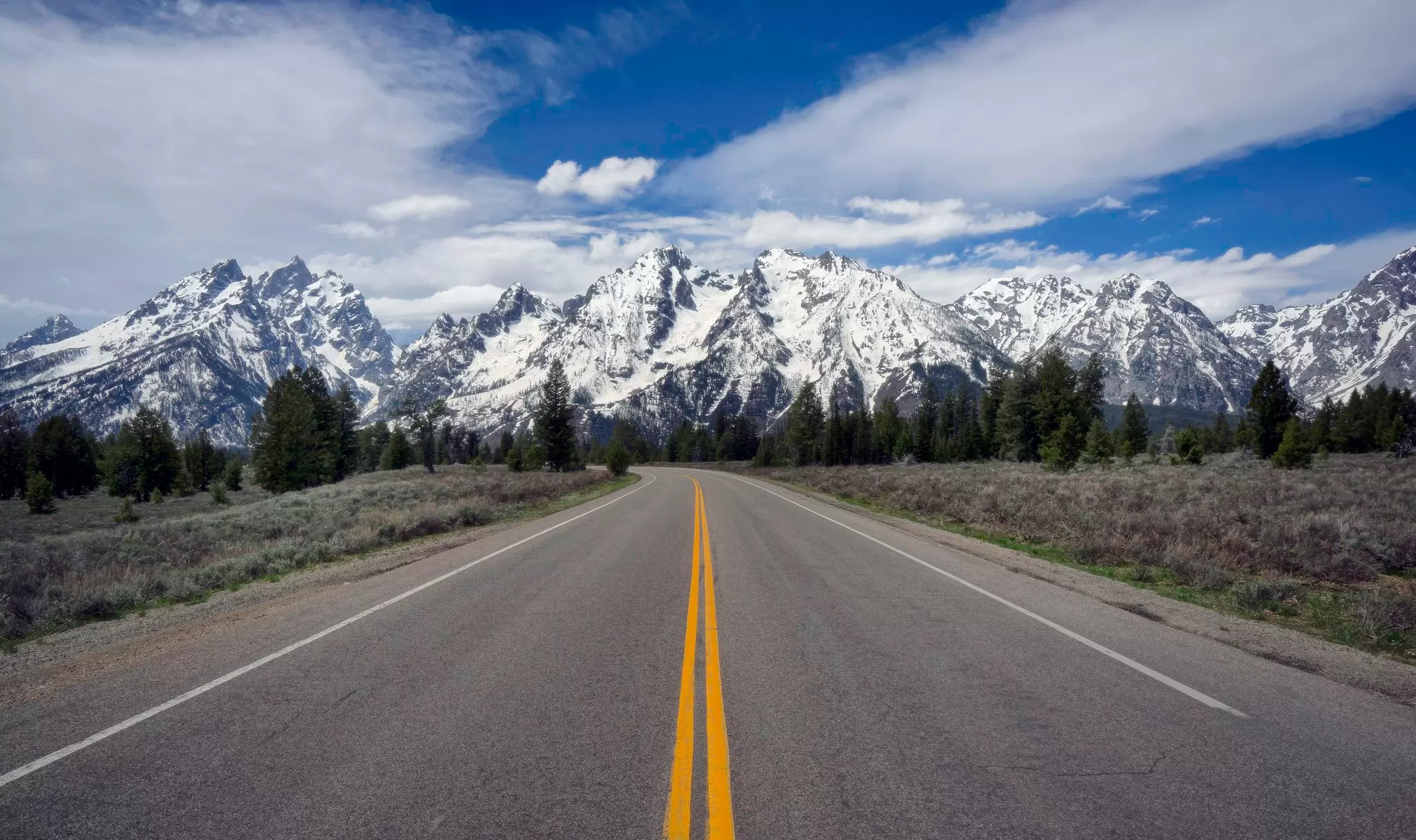 Cruise toward that Rocky Mountain ridge with the perfect soundtrack. Jeff R Clow / Getty Images