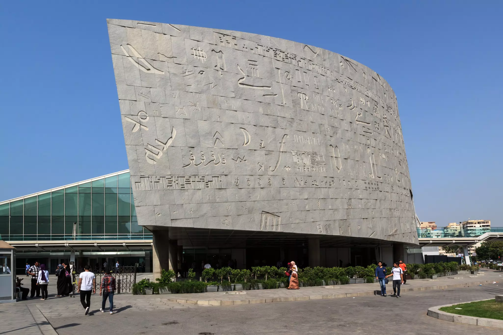 The script-covered modern facade of a library in Egypt.