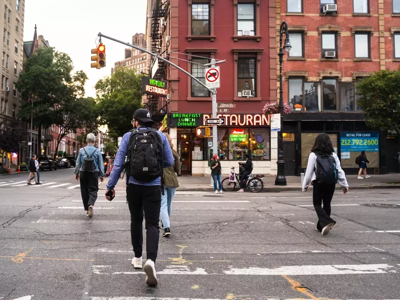 Street scene from The West Village in Manhattan with people crossing the street. 
