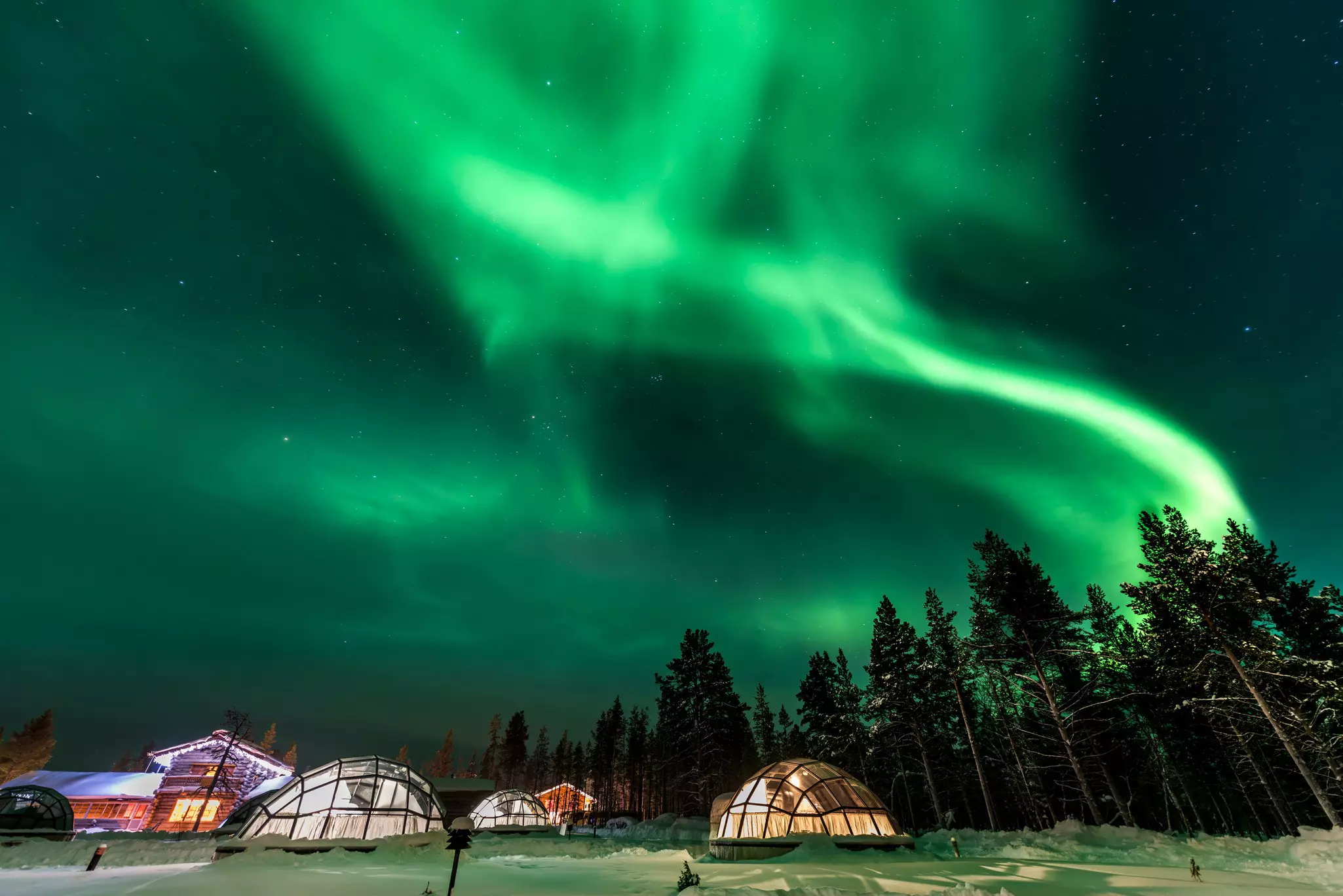 shutterstock_718460992Green powerful bright aurora above igloo house in Finland.jpg