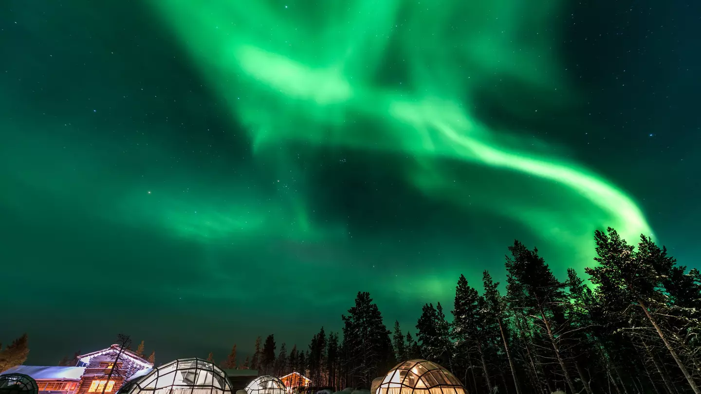 shutterstock_718460992Green powerful bright aurora above igloo house in Finland.jpg