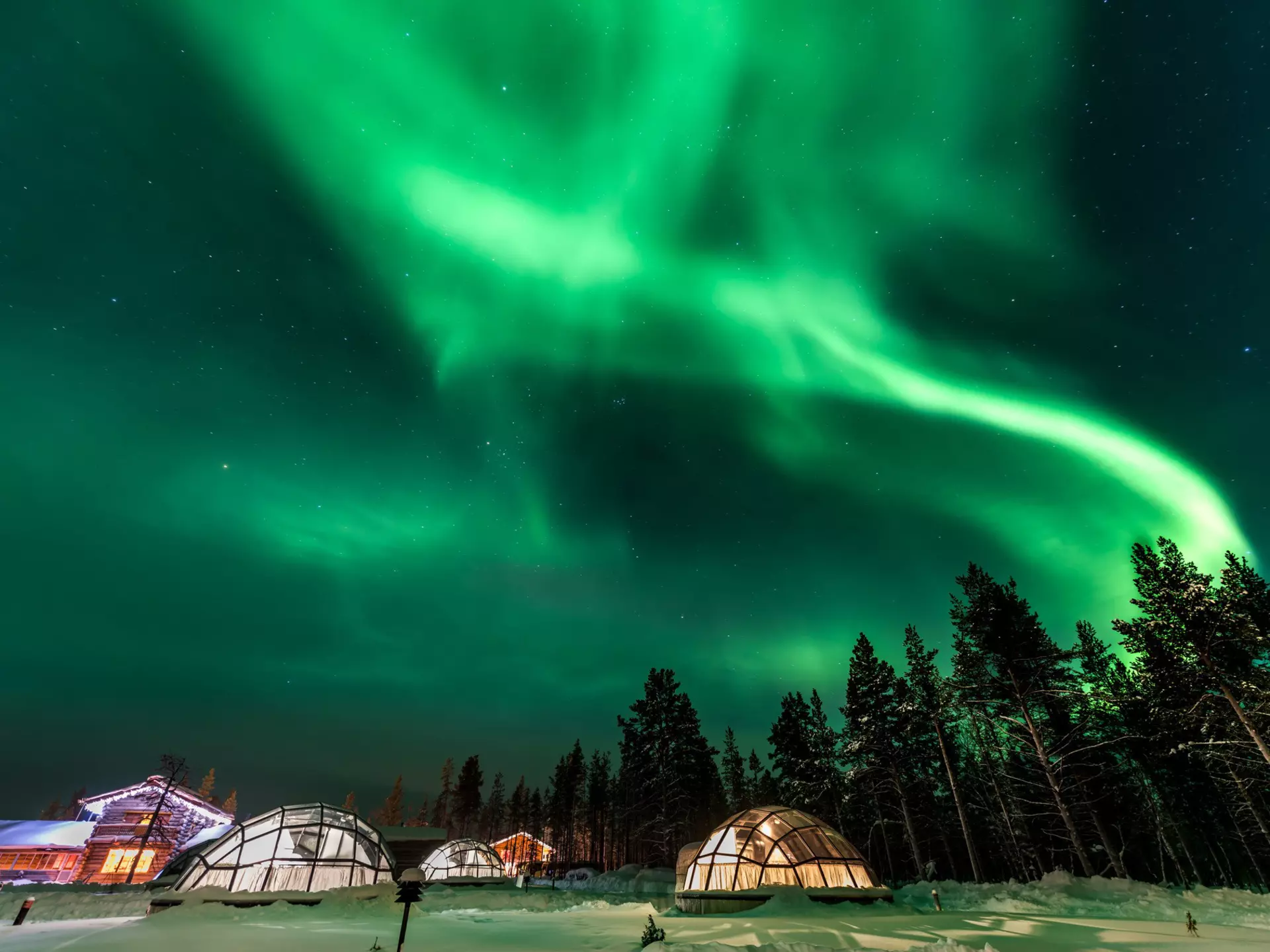 shutterstock_718460992Green powerful bright aurora above igloo house in Finland.jpg