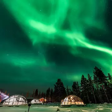 shutterstock_718460992Green powerful bright aurora above igloo house in Finland.jpg