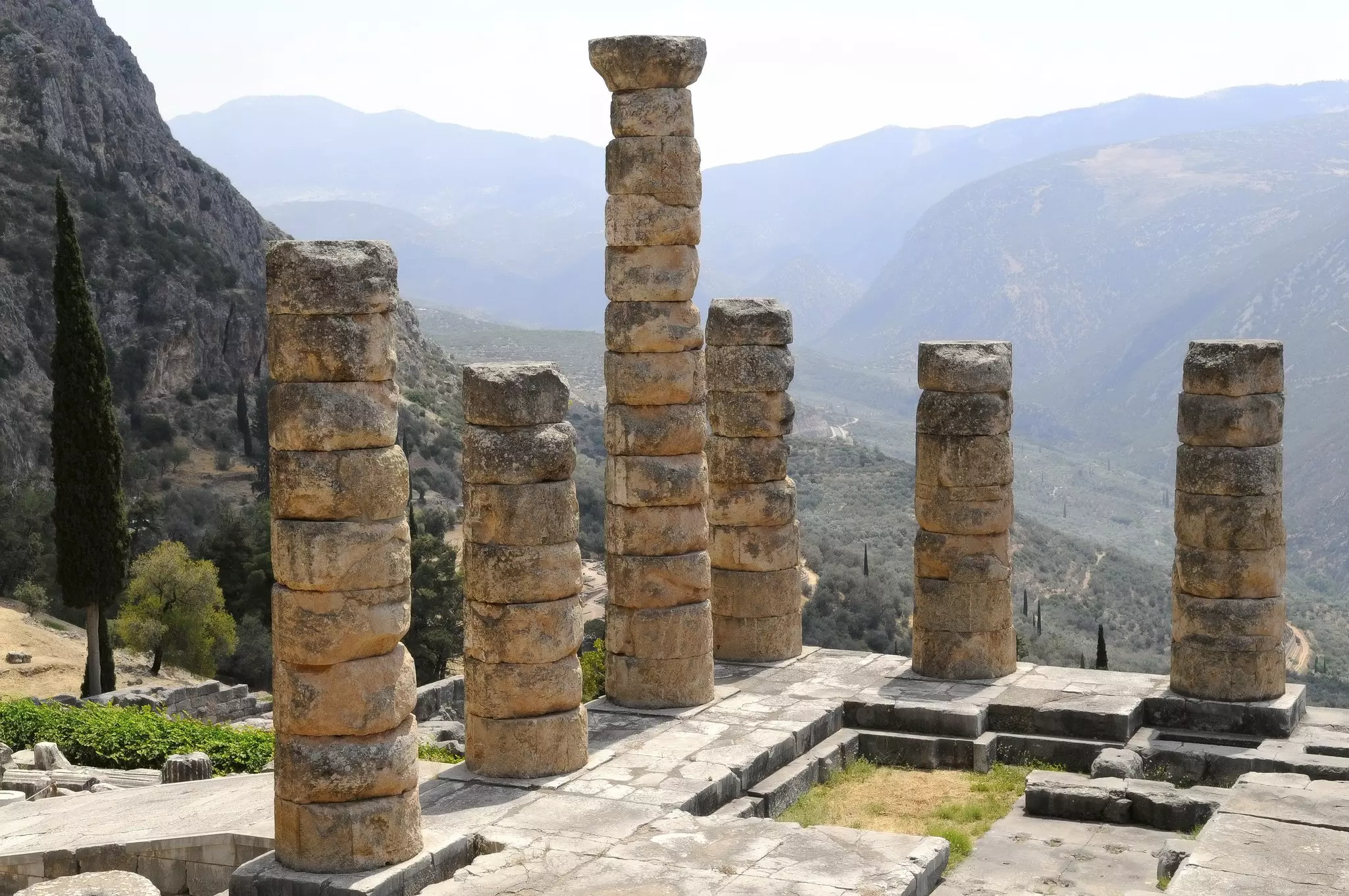 Ruined columns at a temple in a mountainous region.