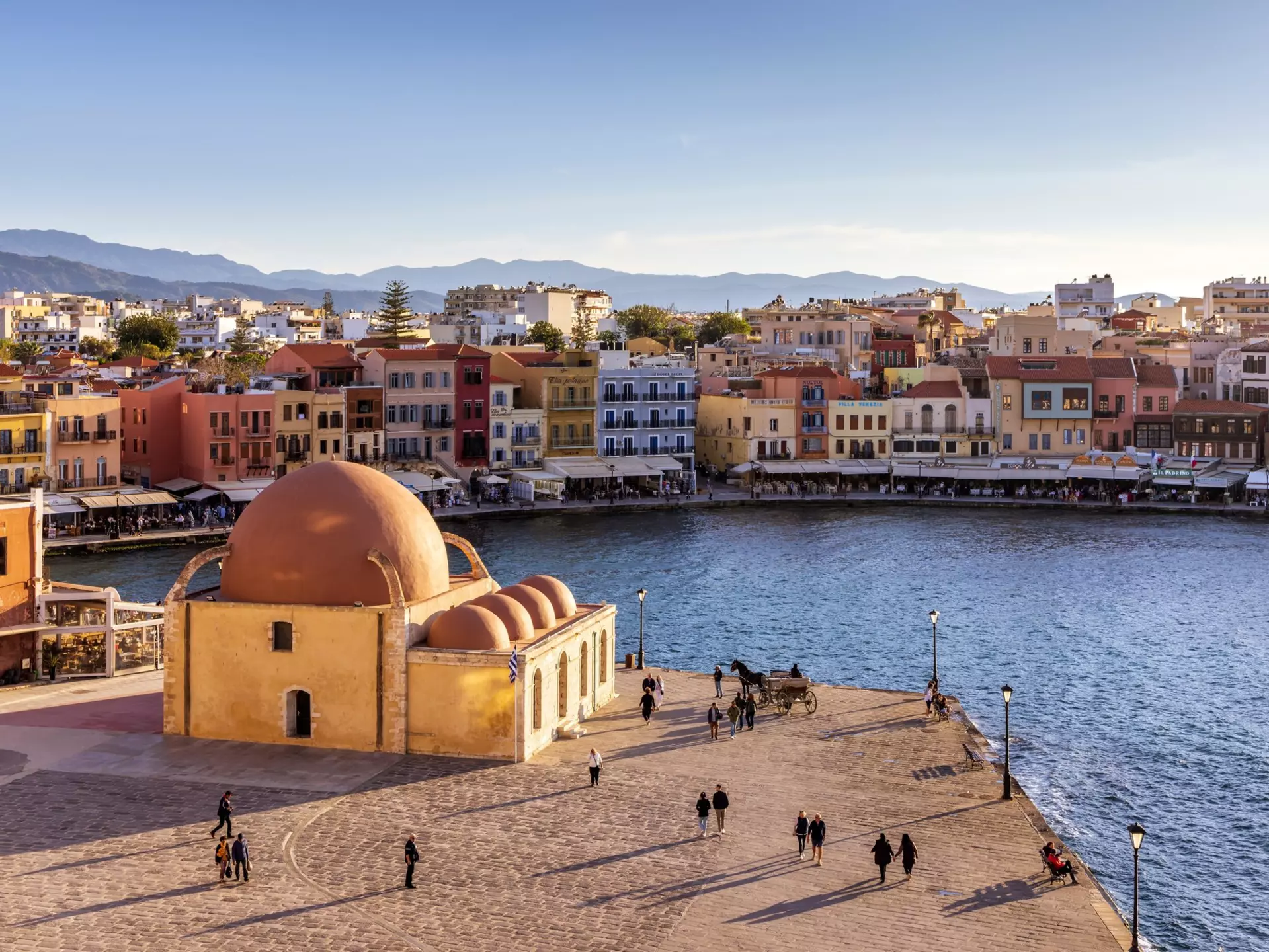 The Venetian harbor at Hania, Crete, with the Kucuk Hasan Pasha Mosque overlooking the water. 