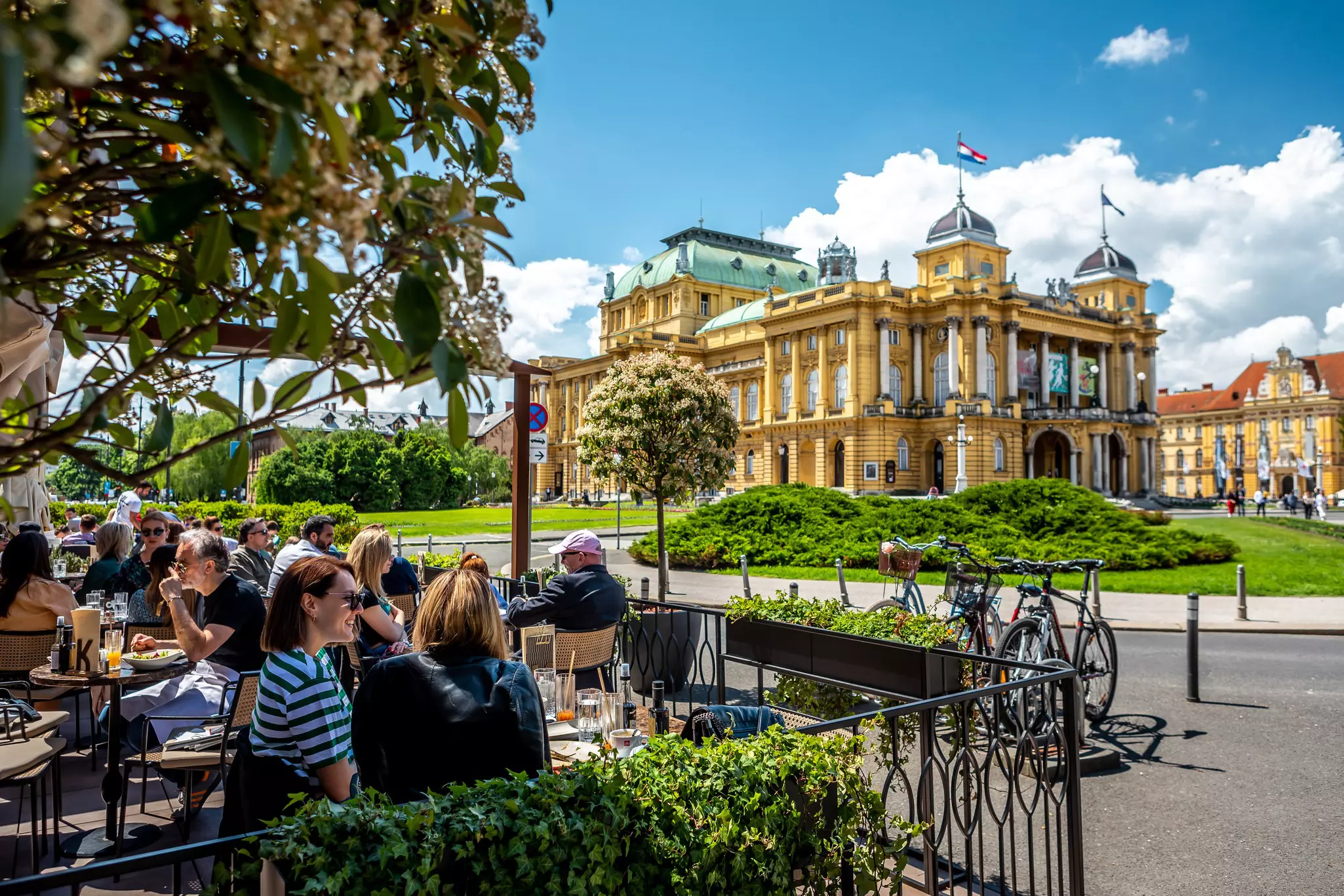 some people sitting at outdoor tables in Zagreb