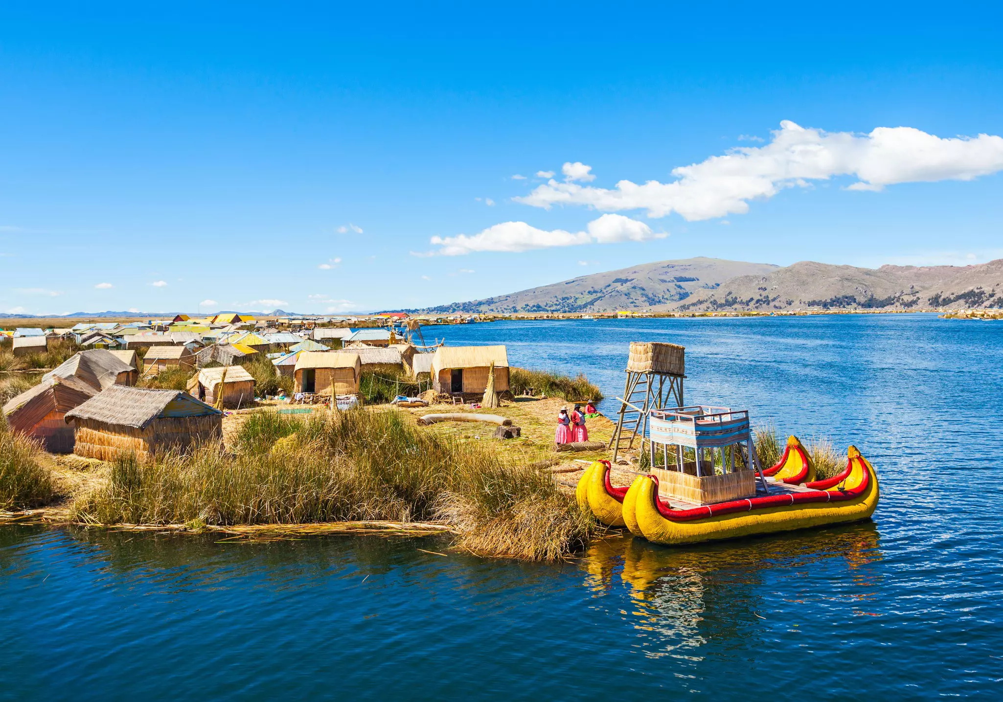 The locals of the Uros floating islands create brightly colored canoe-style boats and more out of the same aquatic bulrush that makes up the islands themselves © Photo courtesy of Promperu