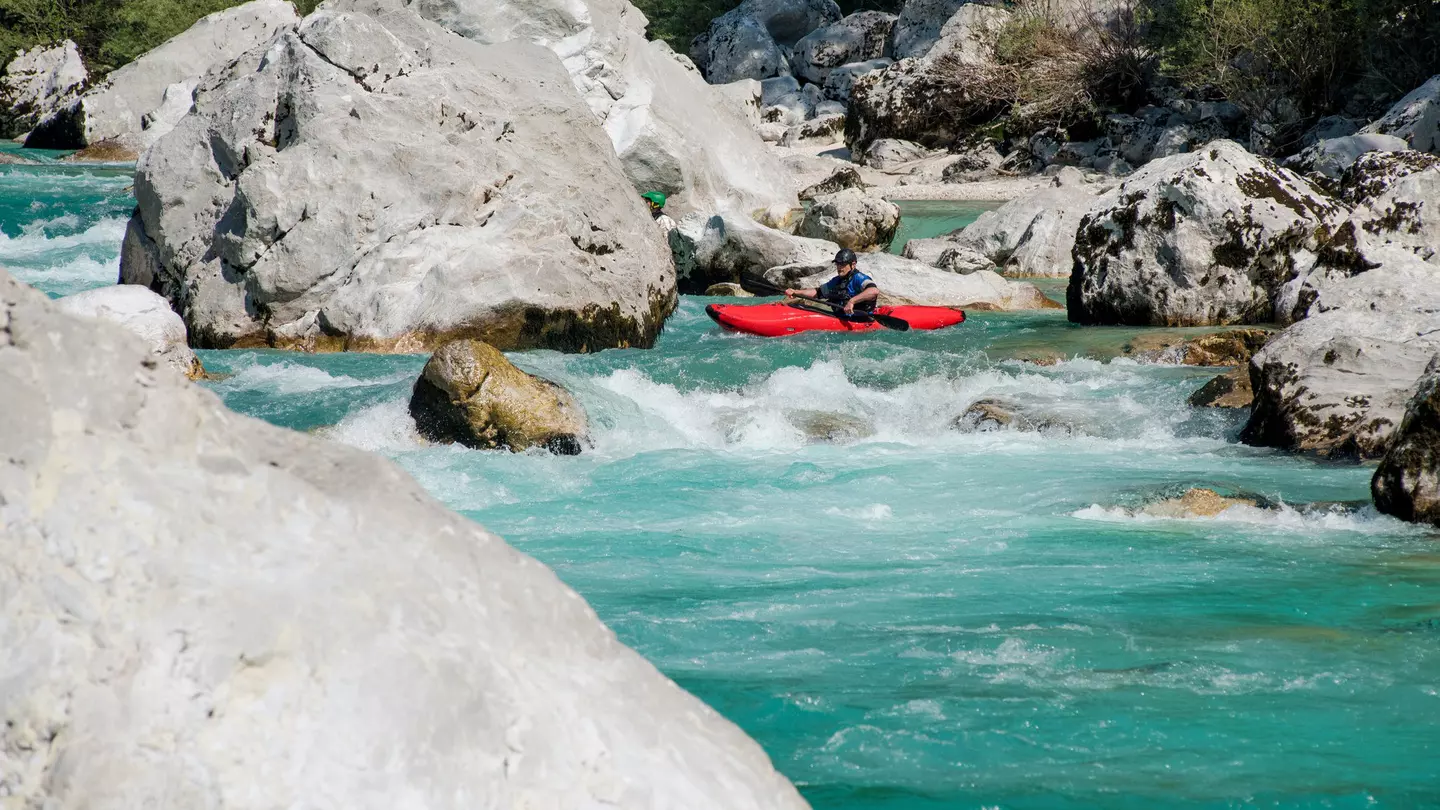 A man kayaking in the turquoise water of the river Soca, in Slovenia. CasarsaGuru / Getty Images