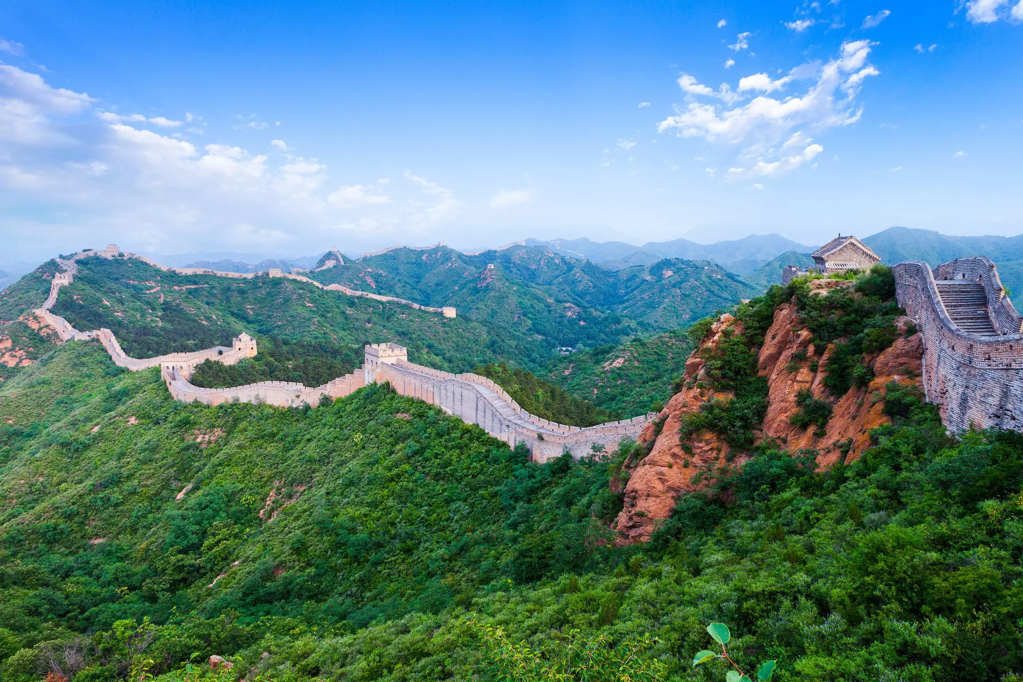 A stretch of the Great Wall across foliage-covered mountains. zhu difeng/Shutterstock