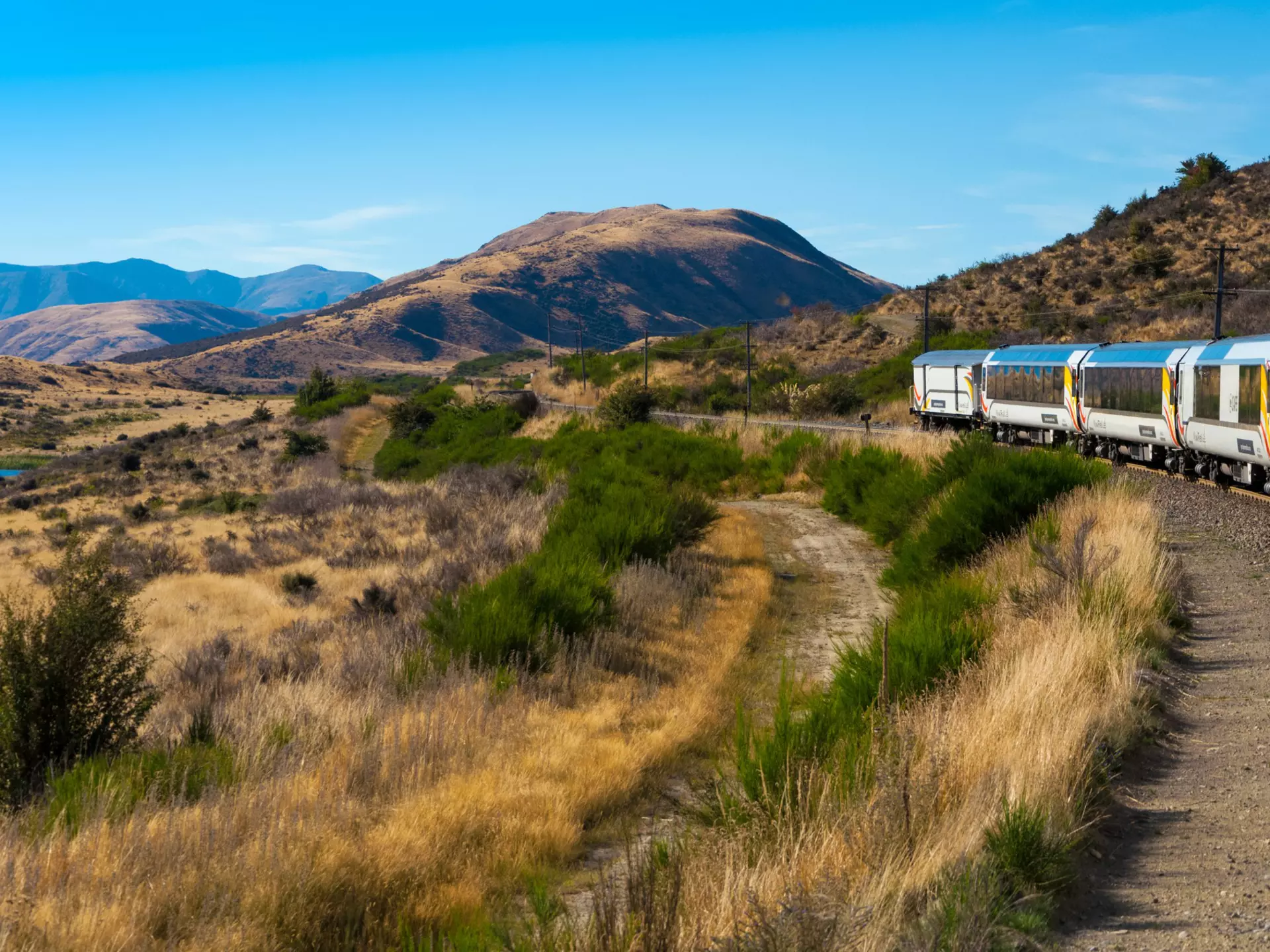 Arthurâ€™s Pass National Park, New Zealand, March 2019. KiwiRail TranzAlpine scenic train, riding among beautiful plains and mountains, popular tourist transportation on South Island  License Type: media  Download Time: 2023-06-21T20:14:23.000Z  User: aniabartoszek  Is Editorial: Yes  purchase_order:  56530/Global Publishing-WIP  