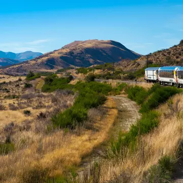 Arthurâ€™s Pass National Park, New Zealand, March 2019. KiwiRail TranzAlpine scenic train, riding among beautiful plains and mountains, popular tourist transportation on South Island  License Type: media  Download Time: 2023-06-21T20:14:23.000Z  User: aniabartoszek  Is Editorial: Yes  purchase_order:  56530/Global Publishing-WIP  