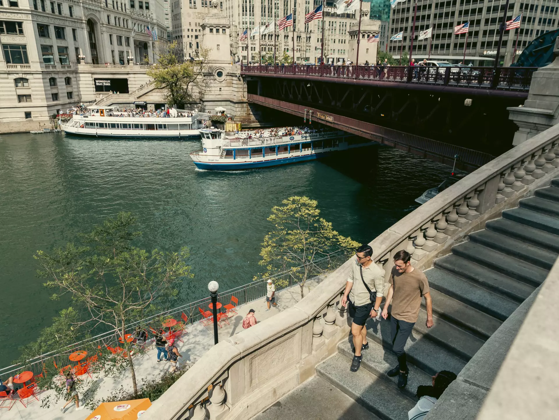 People walking along the Riverwalk in Chicago.