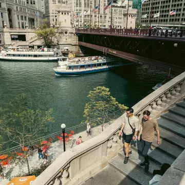 People walking along the Riverwalk in Chicago.