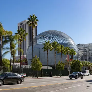 Los Angeles, United States - November, 2022: A picture of the large dome of the Academy Museum of Motion Pictures and the nearby palm trees.  License Type: media  Download Time: 2023-10-05T13:36:23.000Z  User: nic.dhoedt_lonelyplanet  Is Editorial: Yes  purchase_order:   