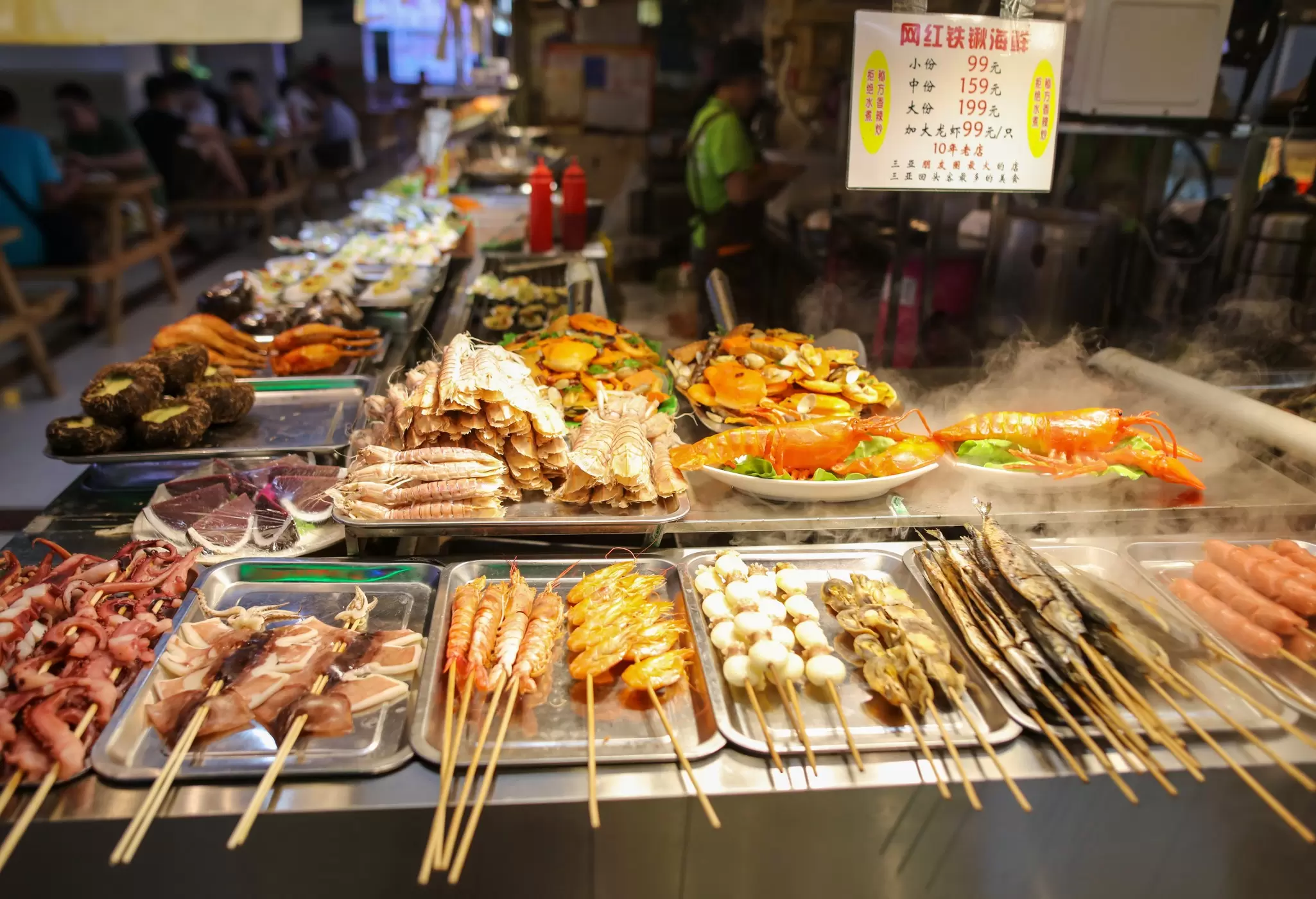 A series of fish skewers lined up on a market stall in Sanya, Hainan, China.