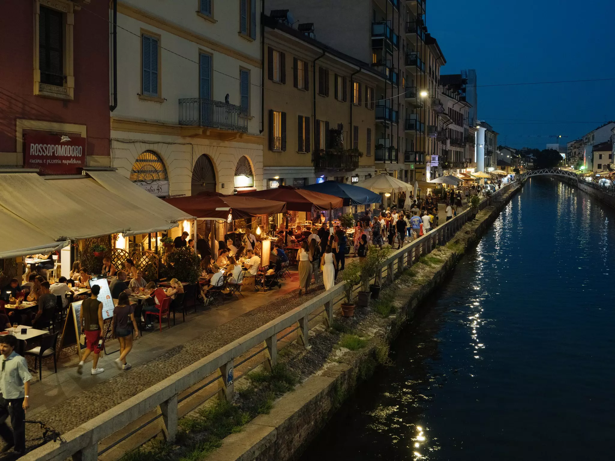 MILANO, ITALY, JULY 2026, Navigli neighborhood, people drinking and eating along the water
.