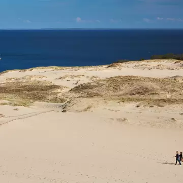 An aerial view of two people on the Parnidis Dune, on the Curonian Spit, Lithuania