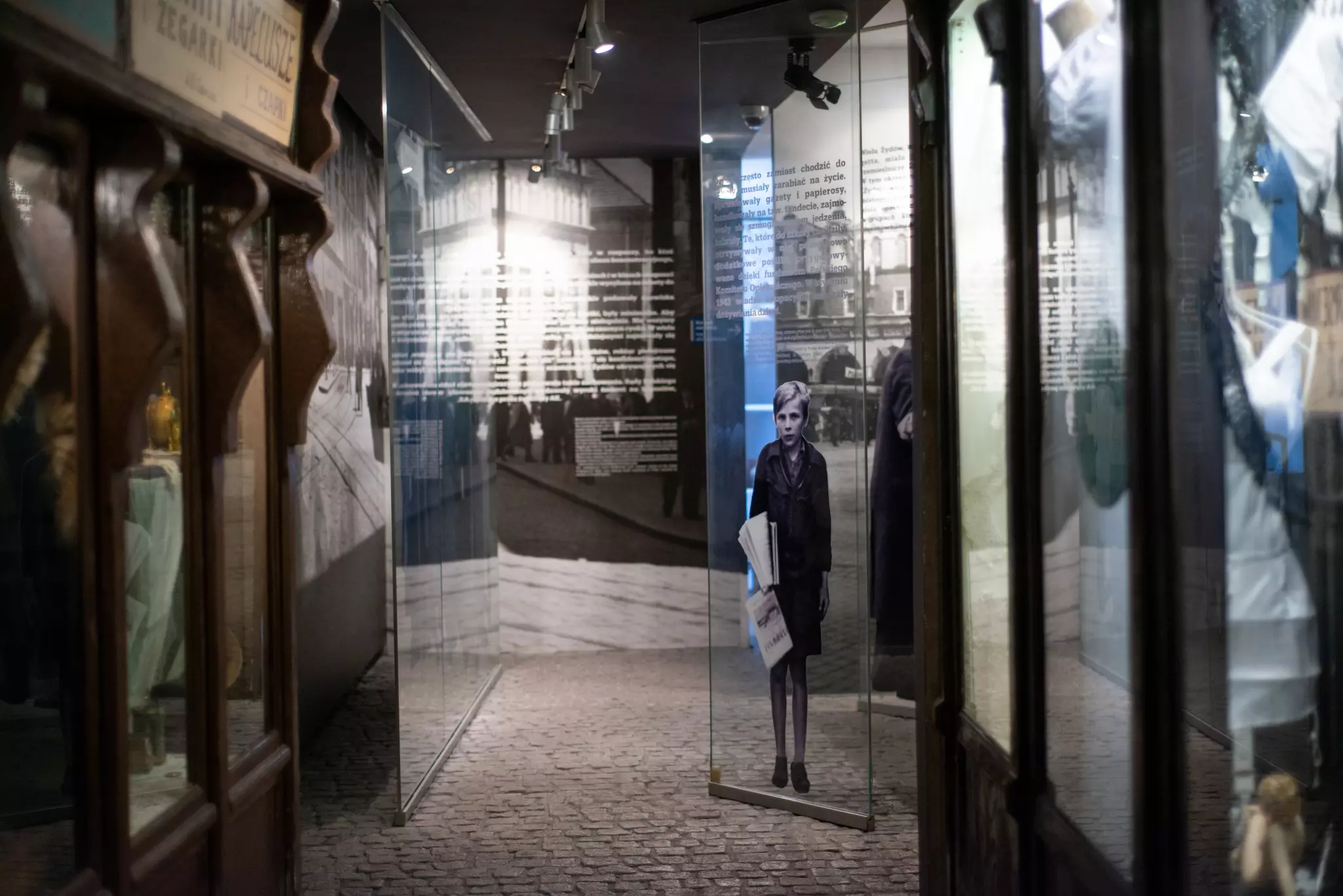 Exhibits inside the Schindler’s Factory museum in Kraków, including a black-and-white image of a child.