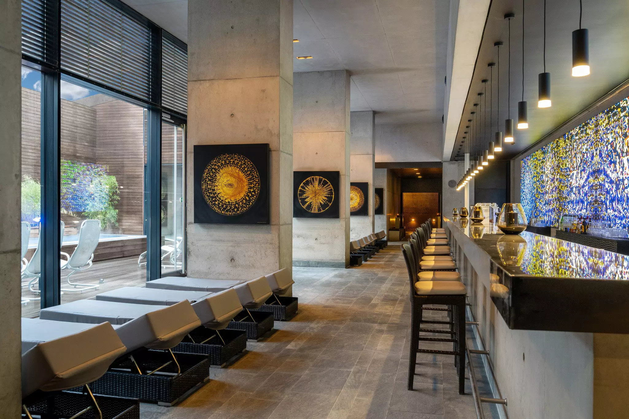 Comfortable loungers lined up along a floor-to-ceiling window.