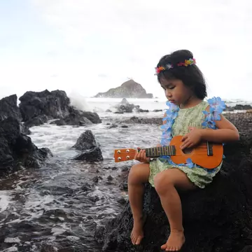 A little girl sits on rock next to the ocean, wearing a Hawaiian lei and playing a ukelele. (Maui, Hawaii)
157426995
Arts And Entertainment, Asian Ethnicity, Babies And Children, Child, Coastline, Concentration, Flower, Garland, Hawaii Islands, Island, Koki Beach, Lifestyle, Little Girls, Little Girls Only, Maui, Music, Music, Musical Instrument, Playing, Plucking An Instrument, Preschooler, Rock, Sea, String Instrument, Travel Locations, Ukelele, Volcanic Rock, Water's Edge
