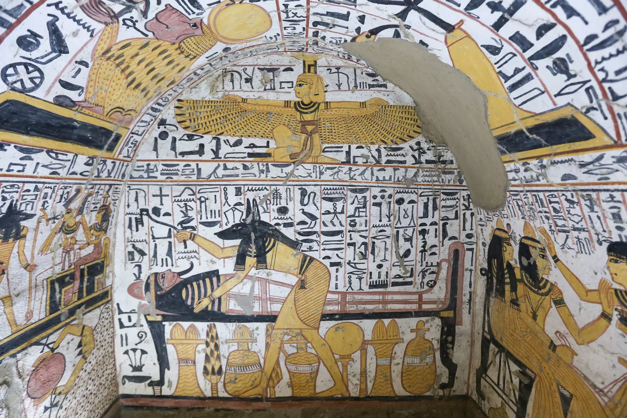 Drawings in yellow and black within a tomb