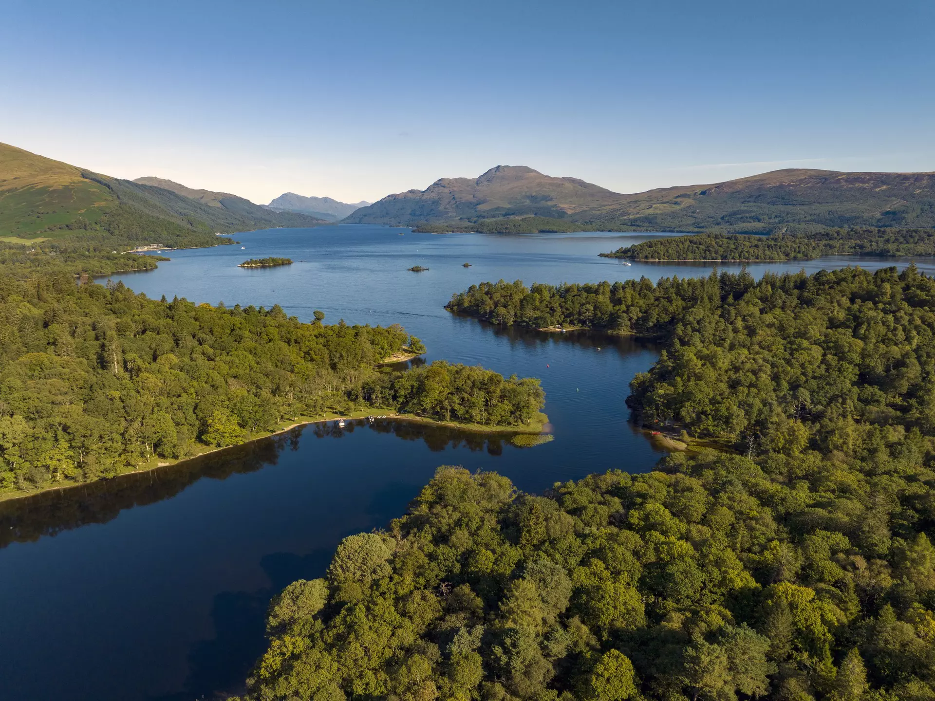 Island-dotted Loch Lomond is a playground for hikers and water sports and boating enthusiasts. Sky View Video (Scotland)/Getty Images