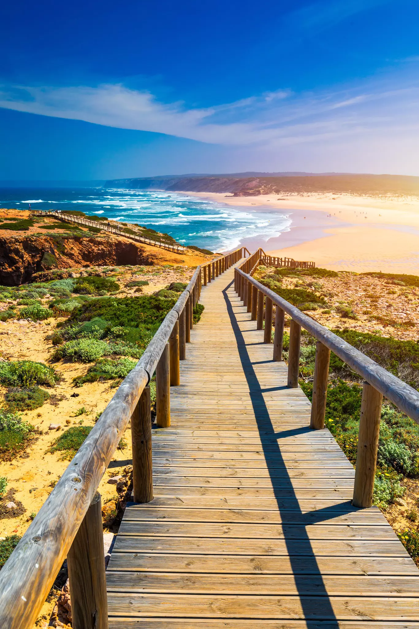 Praia da Bordeira and boardwalks forming part of the trail of tides or Pontal da Carrapateira walk in Portugal. 
