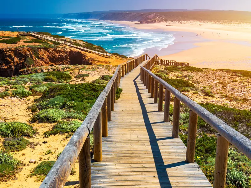 Praia da Bordeira and boardwalks forming part of the trail of tides or Pontal da Carrapateira walk in Portugal. 