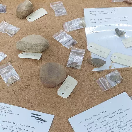 rocks tagged and in baggies on a sandy colored background