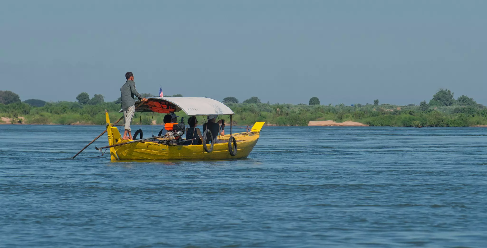 Tourists spotting Irrawaddy dolphins in the Mekong River on a sunny day near the town of Kratie  in Cambodia
