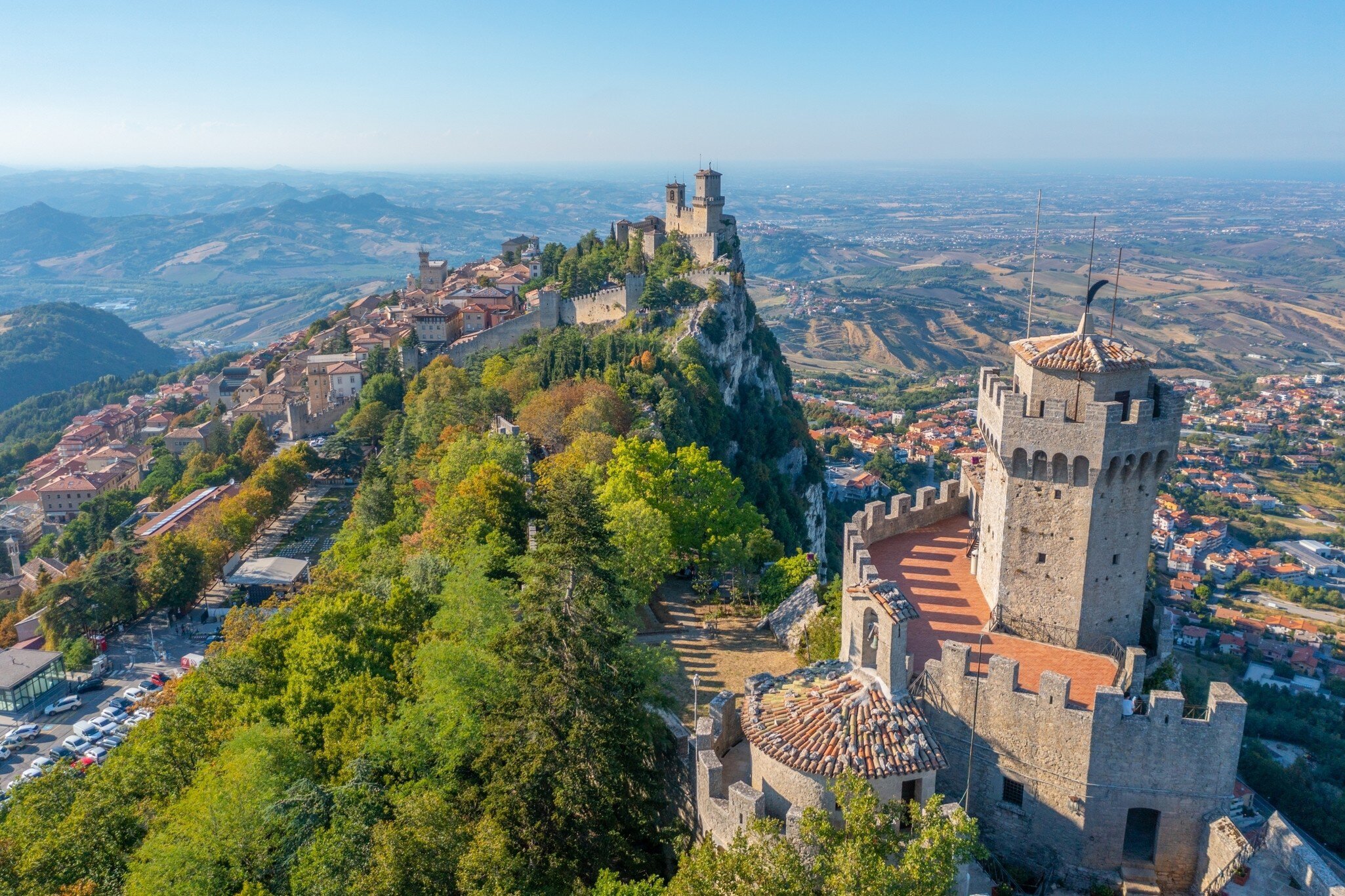 Aerial view of San Marino dominated by Torre Guaita and Torre Cesta, Italy.