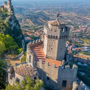 Aerial view of San Marino dominated by Torre Guaita and Torre Cesta, Italy.