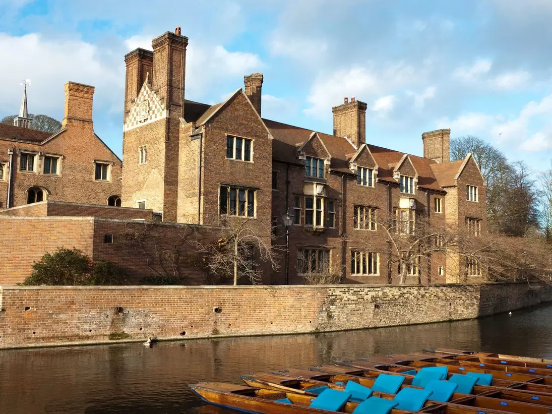 Magdalene college, Cambridge University. Quayside view with punts moored on the bank of the River Cam
