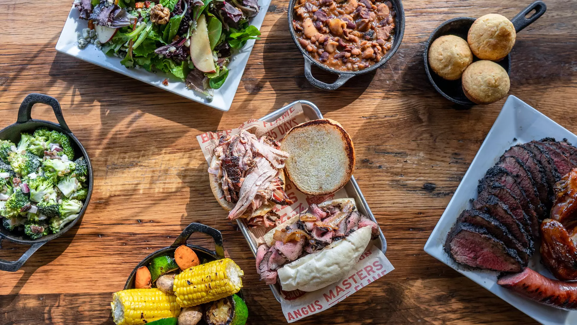 Bbq food and sides on wood table
