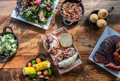 Bbq food and sides on wood table
