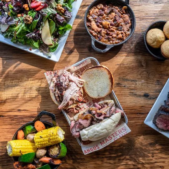 Bbq food and sides on wood table