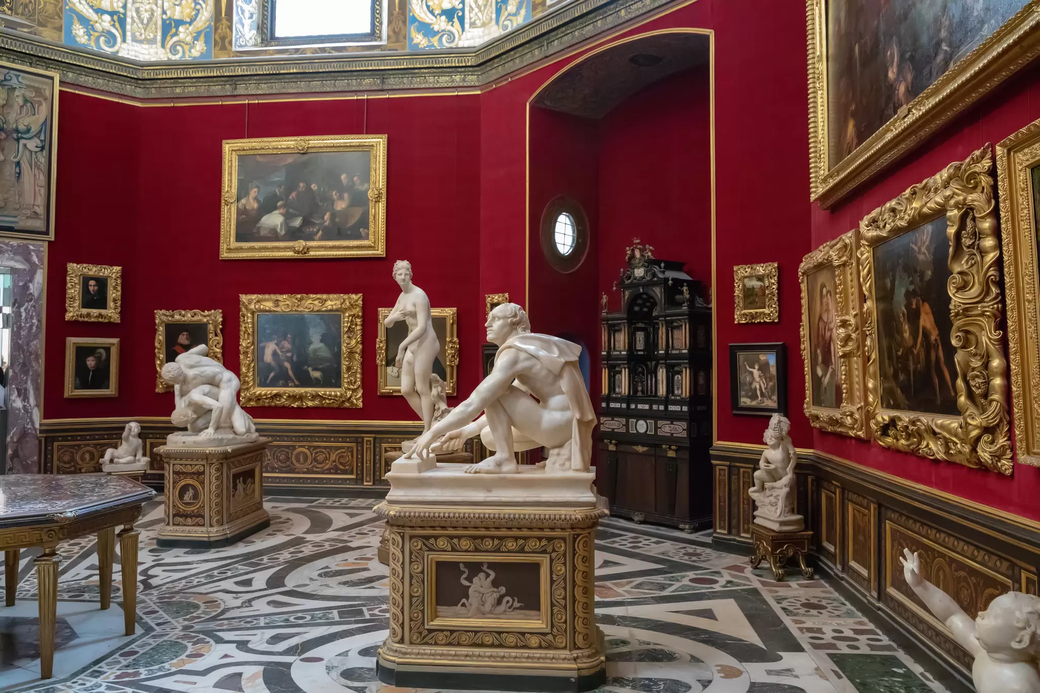 Statues inside the Tribuna degli Uffizi room at the Galleria degli Uffizi in Florence, Italy.