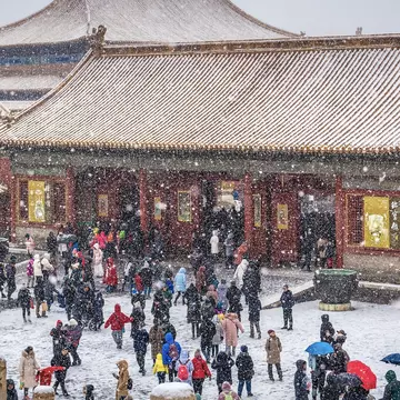 Snow falls on the Hall of Preserving Harmony, the Forbidden City, Beijing, China. Fotokon/Shutterstock