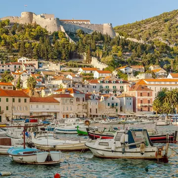 Hvar harbour in the old town of Hvar and the Spanish fortress above the town, Dalmatia, Croatia