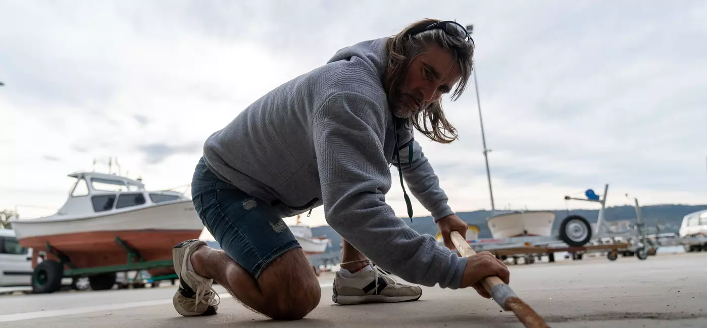 Roberto Vidal Pombo, a percebeiros, hones the blade of his scraper before setting out.