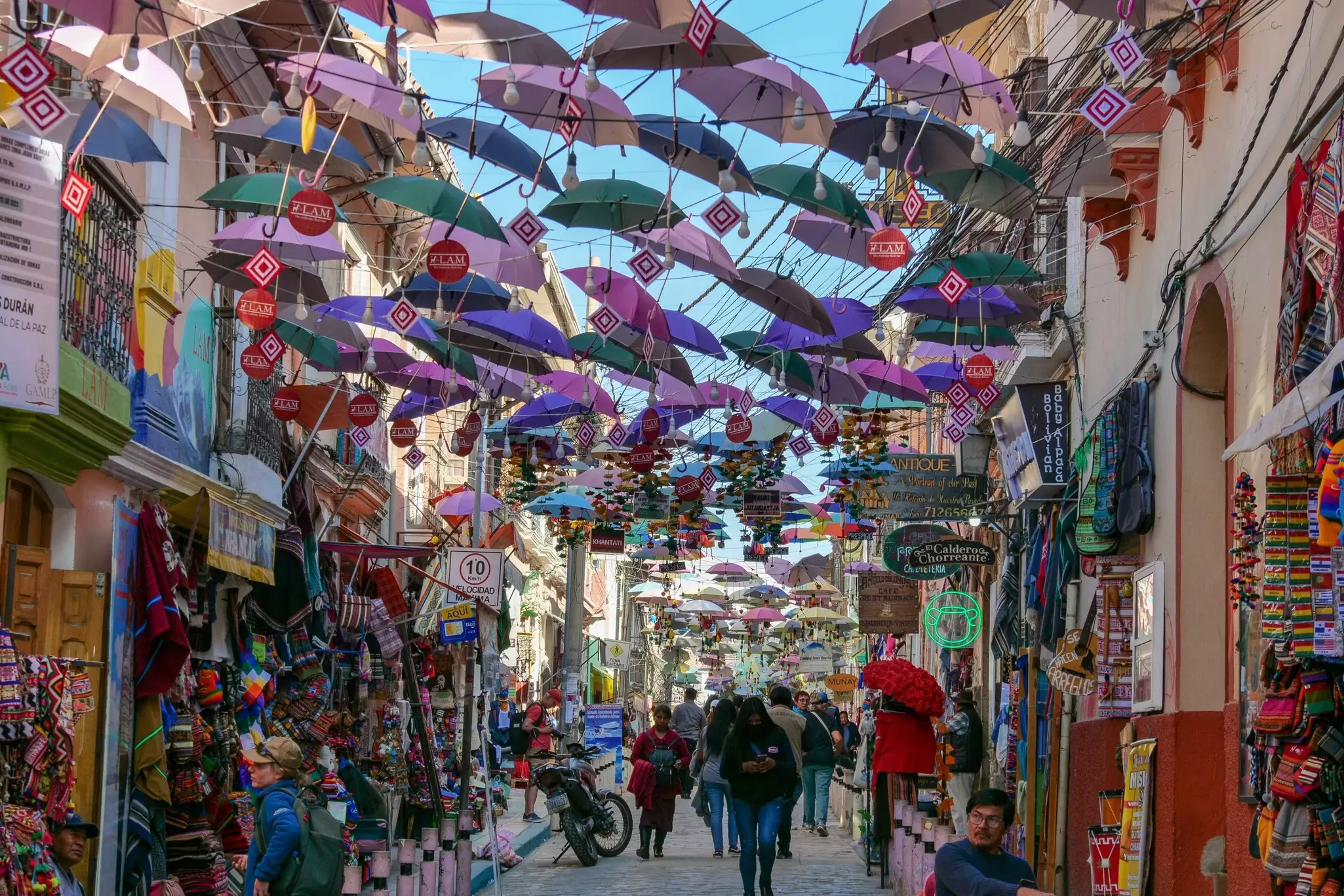 Colorful tourist market, Mercado de Las Brujas in La Paz, Bolivia, with umbrellas hanging from the top.