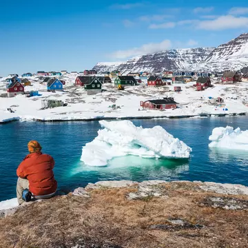 Tourist admiring wonderful views of Qeqertarsuaq, a small town of Greenland  ©Yongyut Kumsri/Shutterstock